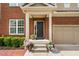 Front door with a covered porch and decorative flower pots at 5028 Blue Jack Oak Dr, Cary, NC 27519