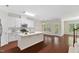 Bright kitchen with white cabinets, stainless appliances, and access to a balcony or patio at 5028 Blue Jack Oak Dr, Cary, NC 27519