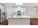 Bright kitchen with white cabinets, a large island, and stainless steel appliances at 5028 Blue Jack Oak Dr, Cary, NC 27519