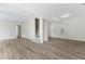 View of the spacious living room with wood-look flooring, recessed lighting, and a stairway to another level at 5028 Blue Jack Oak Dr, Cary, NC 27519