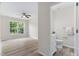 View of a powder room off the living room; the living room has wood-look flooring and a ceiling fan at 5028 Blue Jack Oak Dr, Cary, NC 27519