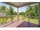 View of screened in patio with wood flooring and railings overlooking a spacious fenced in backyard at 5028 Blue Jack Oak Dr, Cary, NC 27519