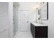 Bright bathroom featuring a shower, double vanity, marble countertop, and modern fixtures at 507 Rosengarten Aly, Raleigh, NC 27603