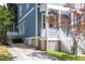 Side view of blue two-story home featuring white stairs and a driveway at 507 Rosengarten Aly, Raleigh, NC 27603