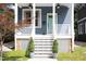 Charming blue home with inviting front porch, complete with potted plants at 507 Rosengarten Aly, Raleigh, NC 27603