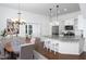 Open concept kitchen features a center island with seating, pendant lighting, and stainless steel appliances at 507 Rosengarten Aly, Raleigh, NC 27603