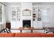 Spacious living room featuring a cozy fireplace with custom shelving and lots of natural light at 507 Rosengarten Aly, Raleigh, NC 27603