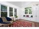 Bright sunroom featuring large windows, built-in storage, and a cozy seating area at 507 Rosengarten Aly, Raleigh, NC 27603