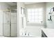 Inviting bathroom with a soaking tub, glass-enclosed shower, and modern fixtures at 514 Alamanni Ct, Graham, NC 27253