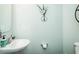 Clean bathroom with a white pedestal sink, light blue walls, and minimalist decor at 514 Alamanni Ct, Graham, NC 27253