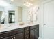 Bright bathroom with double sinks, dark cabinets, and a large mirror above the vanity at 514 Alamanni Ct, Graham, NC 27253