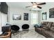 Cozy bedroom with leather sofa, ceiling fan, movie posters and comfortable seating at 514 Alamanni Ct, Graham, NC 27253