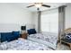 Bright bedroom with matching twin beds, blue pillows, a ceiling fan, and soft lighting at 514 Alamanni Ct, Graham, NC 27253