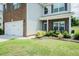 Well maintained lawn with garden beds frames the front of this charming brick and vinyl home at 514 Alamanni Ct, Graham, NC 27253