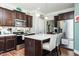 Charming kitchen with a center island, stainless steel appliances, and warm wood floors at 514 Alamanni Ct, Graham, NC 27253