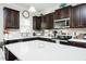 Modern kitchen featuring dark wood cabinets, white countertops and subway tile backsplash at 514 Alamanni Ct, Graham, NC 27253