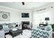 Bright living room with a corner fireplace, comfortable seating, and plenty of natural light at 514 Alamanni Ct, Graham, NC 27253