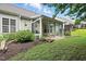Charming backyard featuring a screened-in porch, lush lawn, and landscaped garden at 5421 Brandy Bay Rd, Raleigh, NC 27613