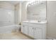 A full bathroom features tile flooring, a combination shower/tub, and double vanity at 5421 Brandy Bay Rd, Raleigh, NC 27613