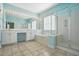 This spacious bathroom has double sinks, a glass-enclosed shower, and large mirror at 5421 Brandy Bay Rd, Raleigh, NC 27613