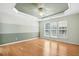 A bedroom featuring bamboo flooring, a modern ceiling fan, and bright natural lighting at 5421 Brandy Bay Rd, Raleigh, NC 27613