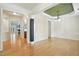 Bright dining room featuring hardwood floors, wainscoting, and a decorative chandelier at 5421 Brandy Bay Rd, Raleigh, NC 27613
