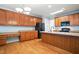 Spacious kitchen with wood cabinetry, a center island, and stainless steel appliances at 5421 Brandy Bay Rd, Raleigh, NC 27613