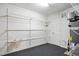 Unfinished storage room on lower level with shelves and door at 5421 Brandy Bay Rd, Raleigh, NC 27613
