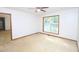 A Primary bedroom with neutral carpet, ceiling fan, and brightly lit window at 622 Enon Rd, Oxford, NC 27565