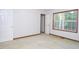 Clean bedroom with a large window and two closet doors at 622 Enon Rd, Oxford, NC 27565