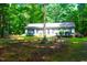 Charming home surrounded by trees with a meticulously maintained lawn and black shutter accents at 622 Enon Rd, Oxford, NC 27565