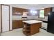 An open kitchen with an island and white appliances at 622 Enon Rd, Oxford, NC 27565