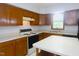 A full kitchen with an island, light wood cabinets, window and white appliances at 622 Enon Rd, Oxford, NC 27565