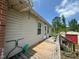 Side view of the home's exterior showing a deck and vinyl siding at 625 Revell Rd, Selma, NC 27576