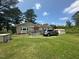 Exterior of home with a lawn, vehicle, and storage shed at 625 Revell Rd, Selma, NC 27576