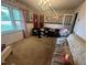 Cozy living room with floral wallpaper, chandelier, and comfortable seating at 625 Revell Rd, Selma, NC 27576