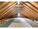 Unfinished attic space featuring exposed wooden beams and natural light at 6708 Wavcott Dr, Fuquay Varina, NC 27526