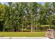 Lush backyard with mature trees and beautiful lake view creates a private oasis at 6708 Wavcott Dr, Fuquay Varina, NC 27526