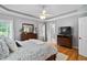 Bright bedroom features hardwood floors, crown molding and neutral paint at 6708 Wavcott Dr, Fuquay Varina, NC 27526
