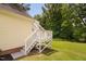 The backyard features a white deck and stairs, perfect for enjoying the outdoors at 6708 Wavcott Dr, Fuquay Varina, NC 27526