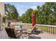 Relax on the expansive deck with colorful outdoor seating and serene views of the lake and trees at 6708 Wavcott Dr, Fuquay Varina, NC 27526