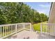 A partial view of the deck and railing overlooking the sprawling, tree-lined backyard at 6708 Wavcott Dr, Fuquay Varina, NC 27526