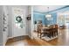 Light-filled dining area featuring hardwood floors, complemented by a chandelier, and a view of an outdoor living space at 6708 Wavcott Dr, Fuquay Varina, NC 27526