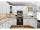 Stylish kitchen with granite countertops, white cabinets, and stainless steel appliances at 6708 Wavcott Dr, Fuquay Varina, NC 27526