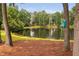 Picturesque view of the lake with tall trees, providing a serene backdrop at 6708 Wavcott Dr, Fuquay Varina, NC 27526