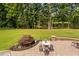Inviting backyard patio offers outdoor seating, mature trees, and a peaceful lake view at 6708 Wavcott Dr, Fuquay Varina, NC 27526