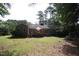 Spacious backyard features a wooden deck with outdoor seating and mature trees at 6717 Valley Dr, Raleigh, NC 27612