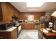 Traditional eat-in kitchen features wood cabinets, stainless steel appliances, and a charming breakfast nook at 6717 Valley Dr, Raleigh, NC 27612