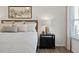 Elegant primary bedroom detail showcasing a stylish nightstand and soft natural light from the window at 70 Freedom Heights Ln # 149, Smithfield, NC 27577