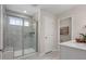 Bathroom featuring walk-in shower, with glass door, seat and window at 700 Ben Ledi Ct, Raleigh, NC 27603